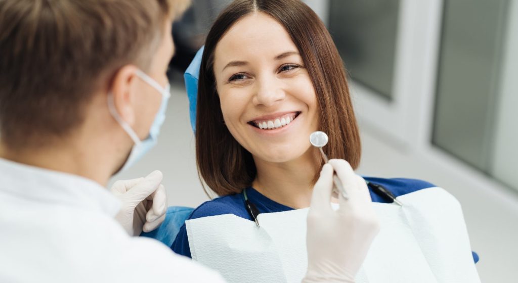 male-professional-dentist-with-gloves-mask-discuss-what-treatment-will-look-like-patient-s-teeth